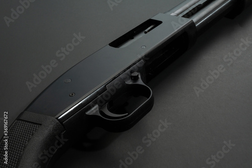 Canvas Print Close up of a 12 gauge shotgun on black background.