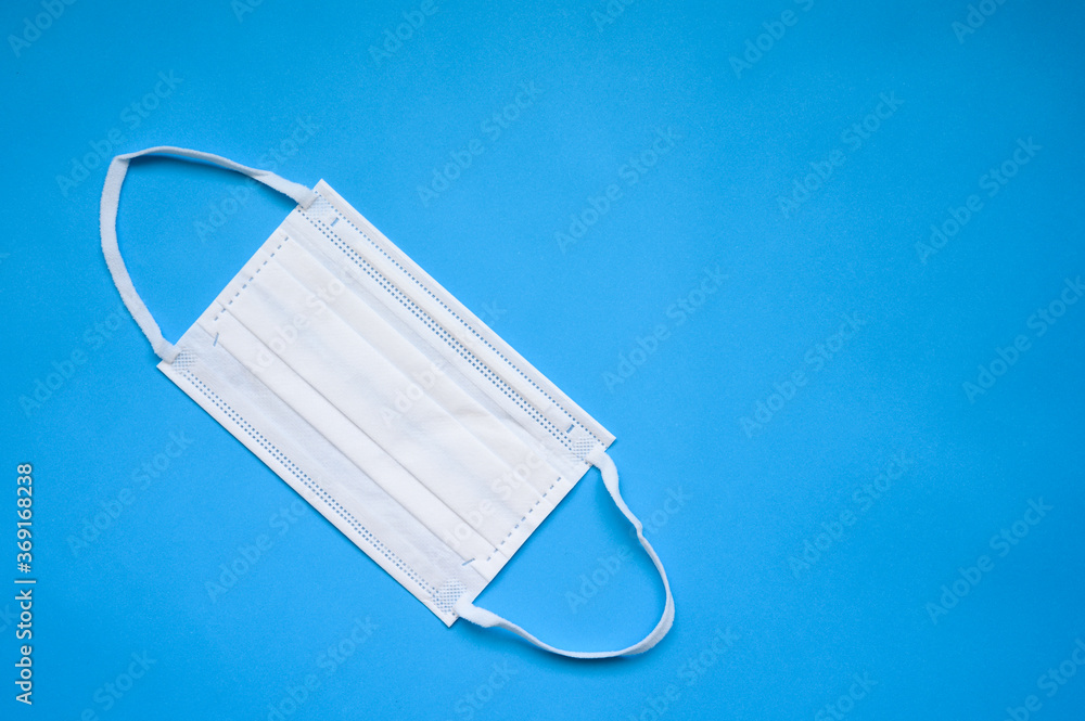 Protective face mask on blue background Protective face mask on blue background
