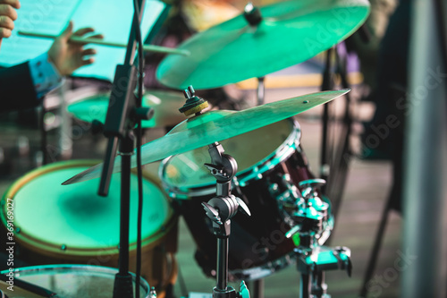Photography Drummer percussionist performing on a stage with drum set kit during jazz rock s