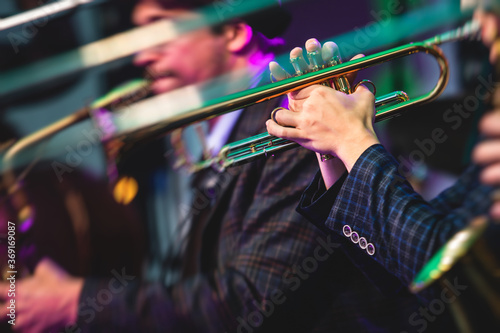 Photography Concert view of a male trumpeter, professional trumpet player with vocalist and