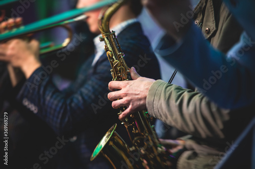 Photography Concert view of a saxophonist, saxophone player with vocalist and musical during