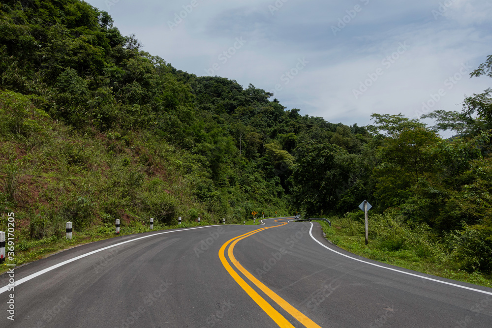 Rural Country Road on the Mountains early in the morning on the Doi Phuka National Reserved Park, Nan Province, Thailand