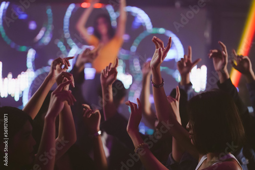 group of young girl dancing in the nightclub, young lady with friends event concert
