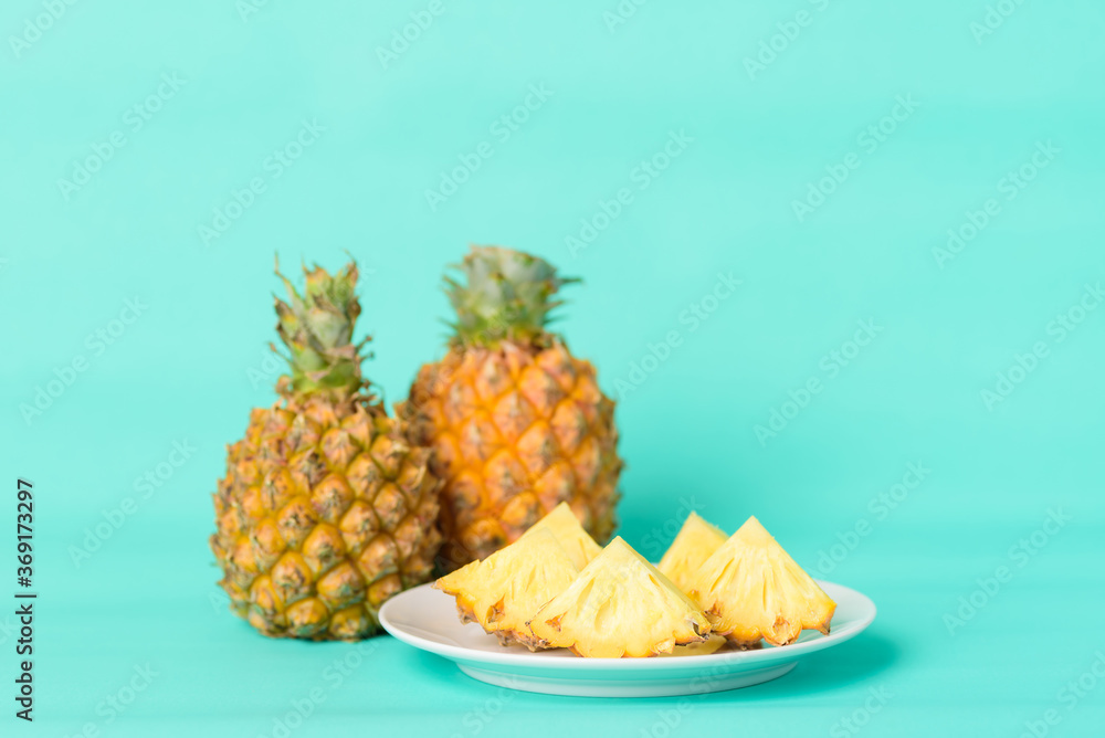 Sliced pineapple fruit on plate with pastel green background, Tropical fruit Sliced pineapple fruit on plate with pastel green background, Tropical fruit