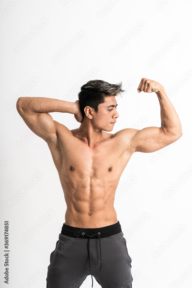 young man showing muscular biceps stand facing forward on isolated background