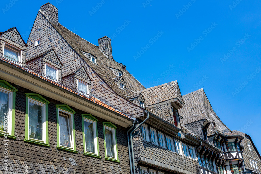 Facade of a building made of natural slate tiles Facade of a building made of natural slate tiles