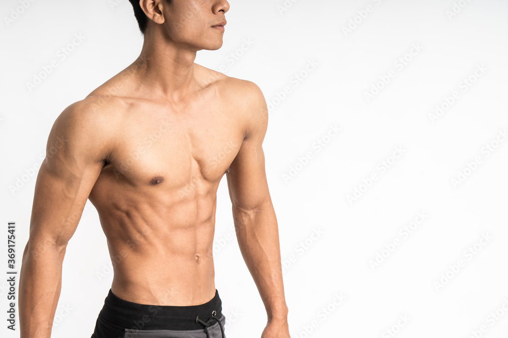 Fototapeta premium sexy man showing muscular abdominal stand facing side on isolated background