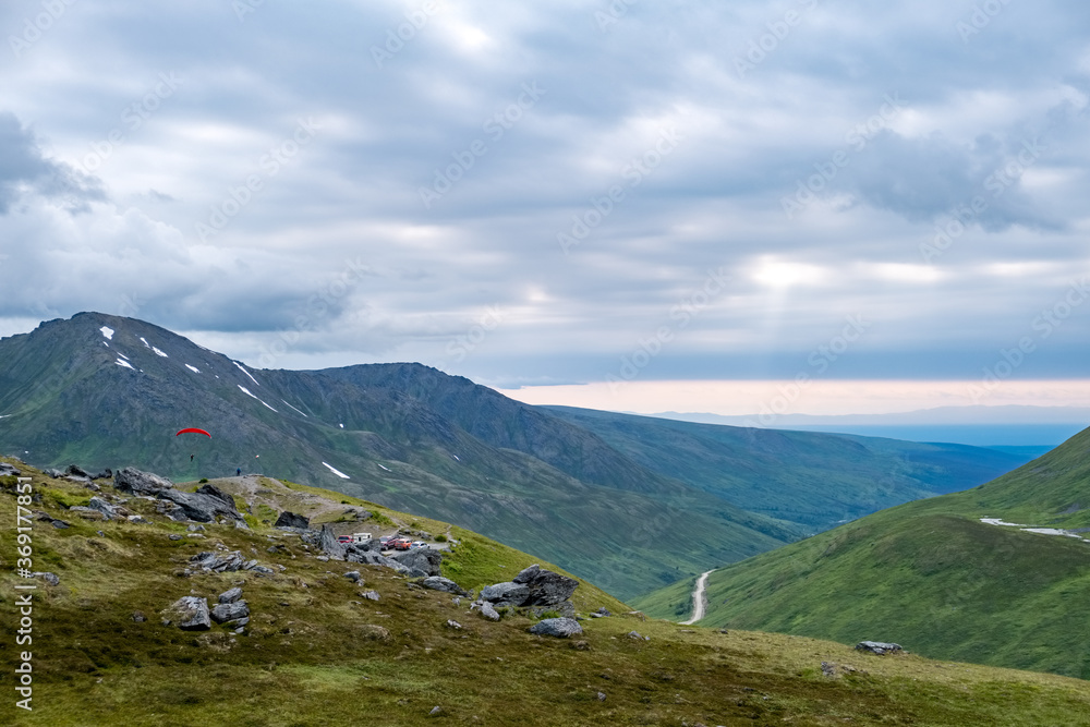 Paragliders depart from Summit Lake, in Hatcher Pass. Paragliders depart from Summit Lake, in Hatcher Pass.
