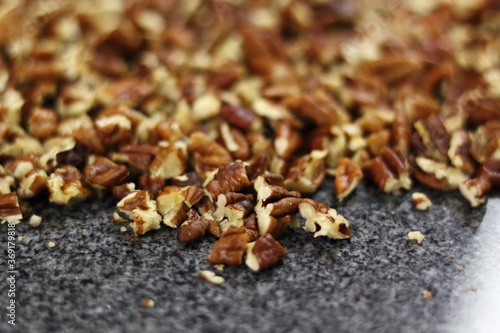 Crushed pecan nuts on granite surface