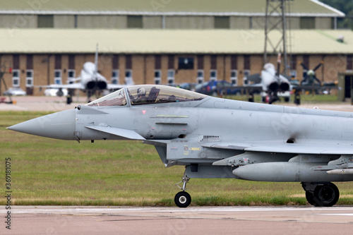 Fighter jet taxiing at a military airbase.