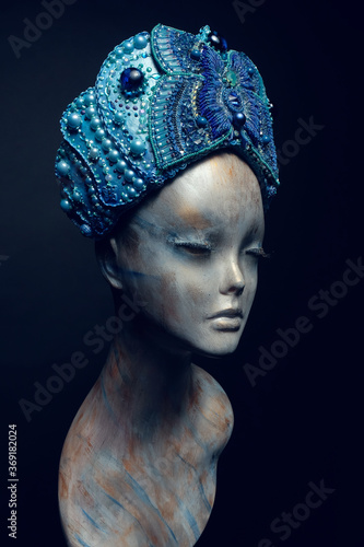 Head of mannequin in creative blue crown with jewels  and pearls