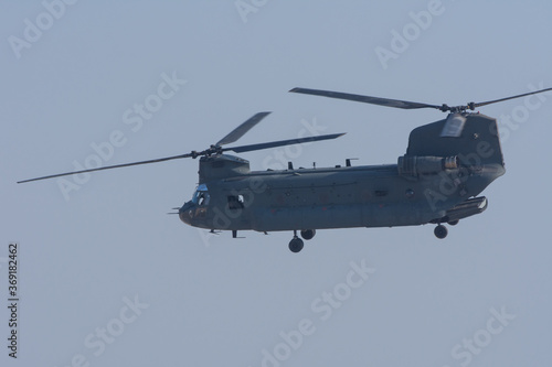 Wallpaper Mural Military combat and war with Chinook helicopter flying through the sky.  Military concept of power, force, strength, air raid. Torontodigital.ca