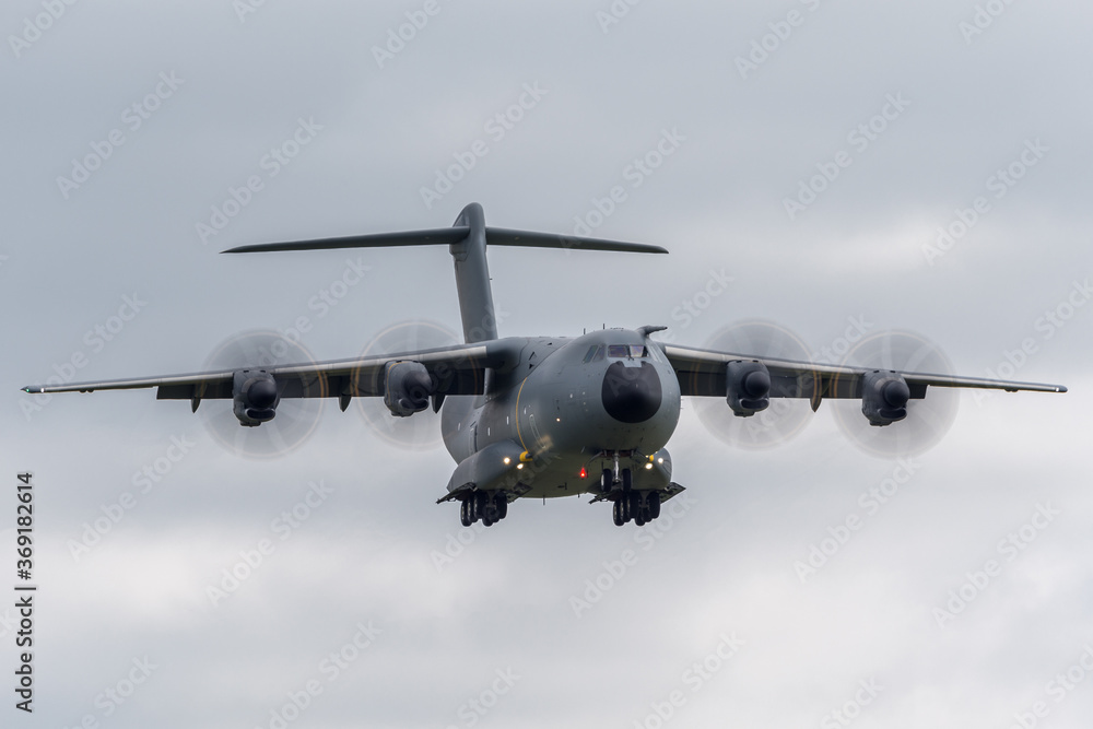 Obraz premium Large four engined military cargo airplane on approach to land.
