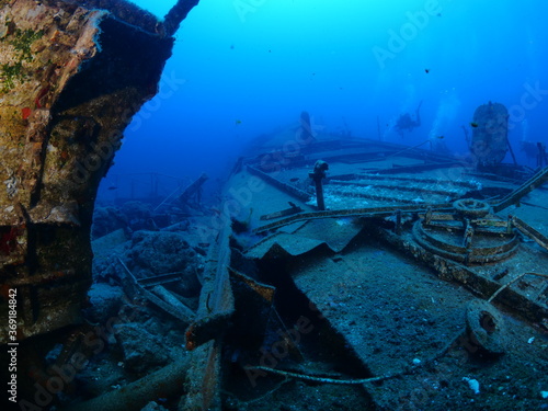 ship wreck underwater scuba divers to search and explore ocean bottom scenery of metal underwater © underocean