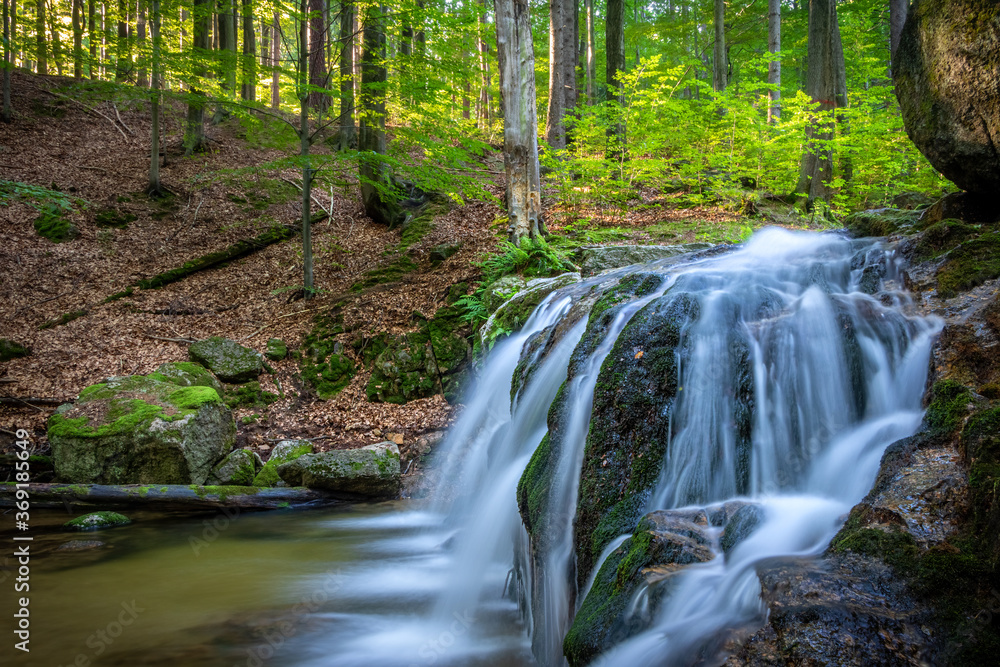 Long exposure of stream waterfalls in summer forest Long exposure of stream waterfalls in summer forest