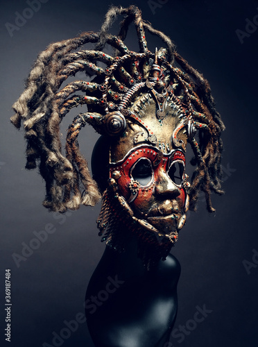 Creative african mask, dark studio background