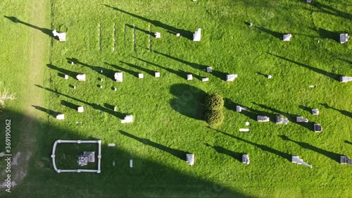 Drone shot of graves in a cemetery. Taken at sunset showing long shadows. photo