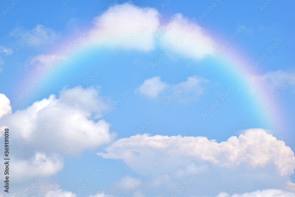 Abstract rainbow on beautiful blue sky and white clouds as background and wallpaper. Abstract rainbow on beautiful blue sky and white clouds as background and wallpaper.