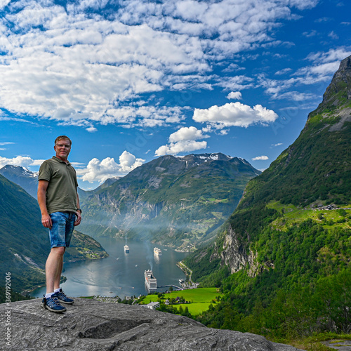 Male tourist standing high near Giranger in Norway © Jonas