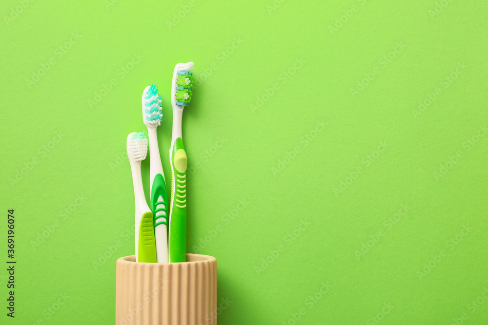 Tooth brushes on color background - obrazy, fototapety, plakaty 