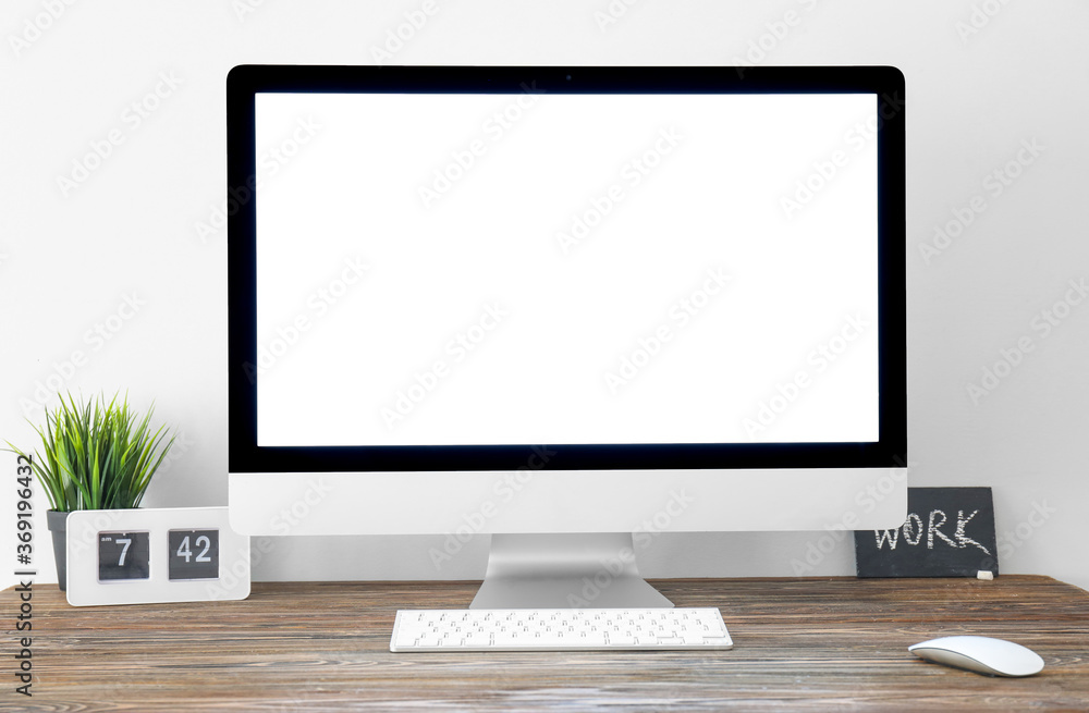 Modern PC monitor with blank screen on table Modern PC monitor with blank screen on table