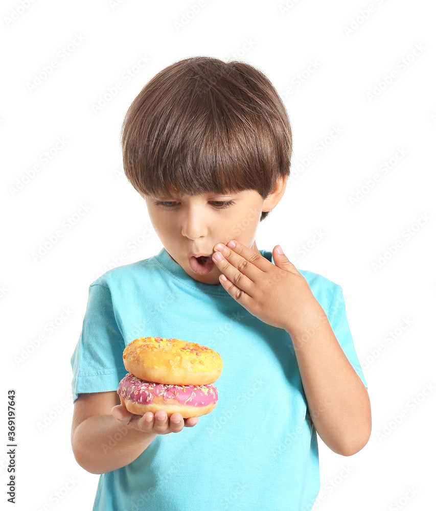 Surprised little boy with donuts on white background Surprised little boy with donuts on white background