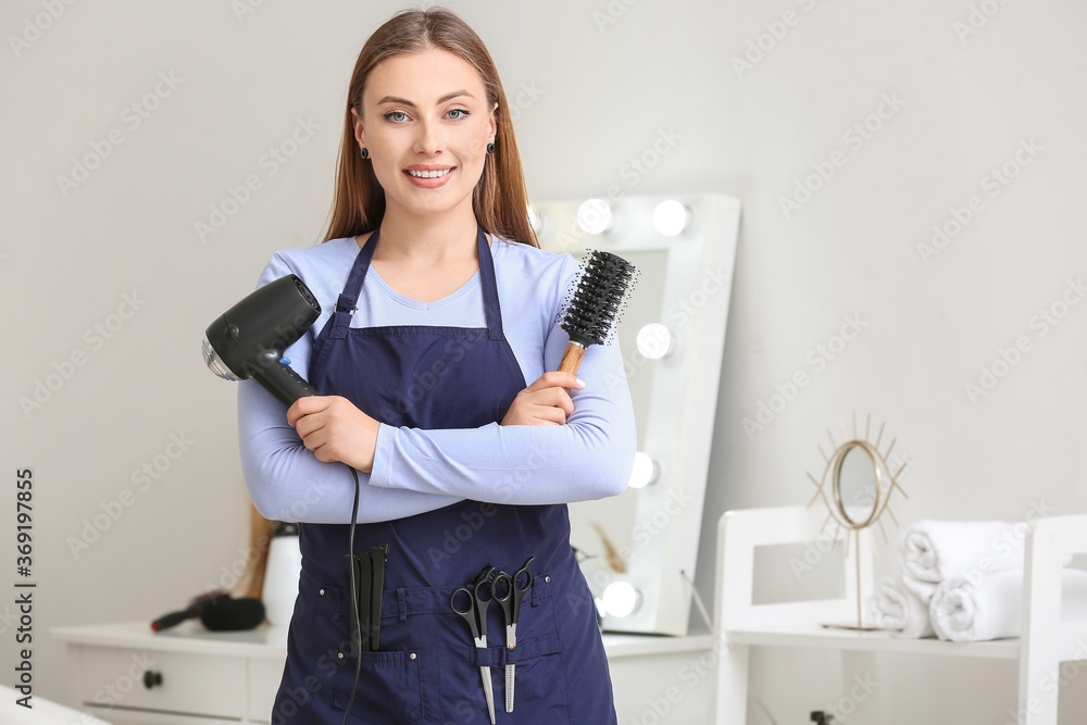 Portrait of female hairdresser in salon