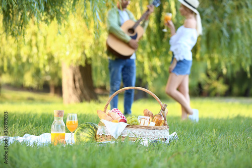 Basket with tasty food and ...