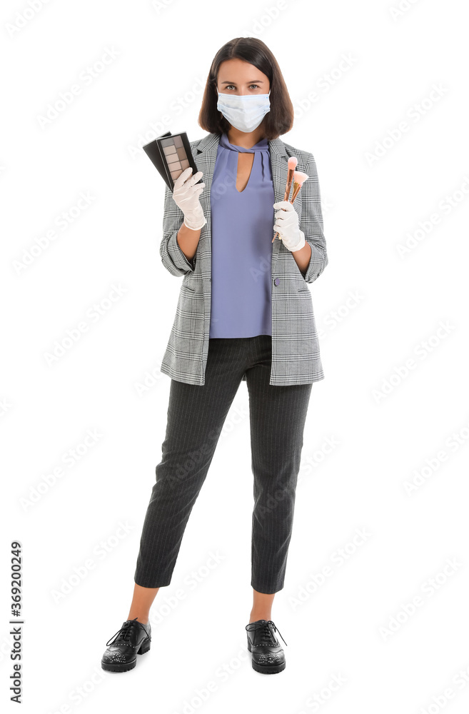 Female makeup artist wearing medical mask on white background. Coronavirus epidemic Female makeup artist wearing medical mask on white background. Coronavirus epidemic