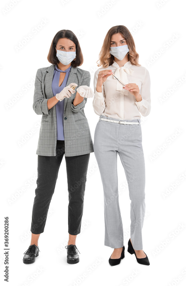 Female makeup artists wearing medical masks on white background. Coronavirus epidemic Female makeup artists wearing medical masks on white background. Coronavirus epidemic