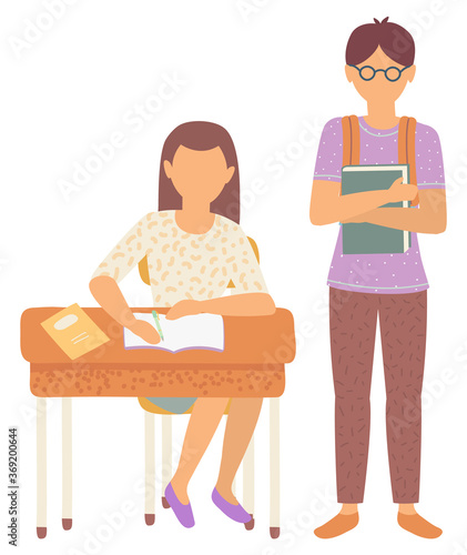 Boy and girl classmates in school vector, isolated schoolboy and schoolgirl flat style characters. Female sitting by wooden desk writing composition. Back to school concept. Flat cartoon