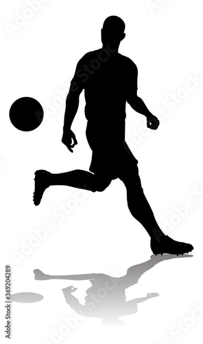 A soccer or football player in silhouette