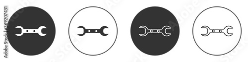 Black Wrench spanner icon isolated on white background. Circle button. Vector Illustration.