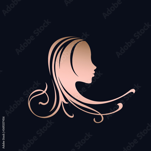 Hair salon and beauty studio logo.Woman with long  wavy hairstyle.Profile view girl portrait silhouette.Shiny rose gold color.Cosmetics and spa icon isolated on dark background.
