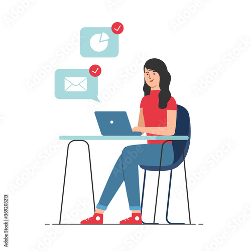 Woman in casual clothes sitting at desk and working on laptop