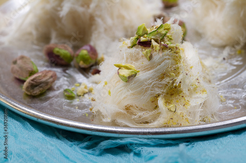 Turkish cotton candy - pishmanie with pistachios. Selective focus photo