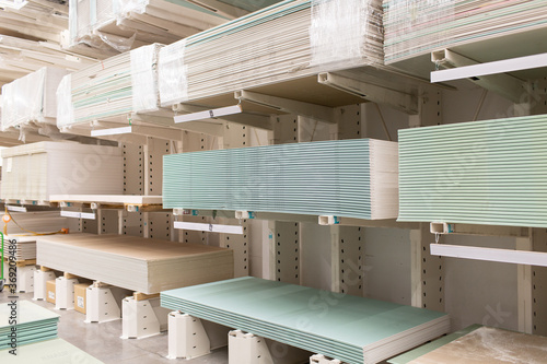Pallet with Drywall sheets plasterboard in the building warehouse store photo