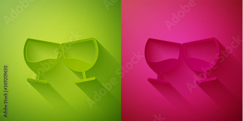 Paper cut Glass of cognac or brandy icon isolated on green and pink background. Paper art style. Vector Illustration.