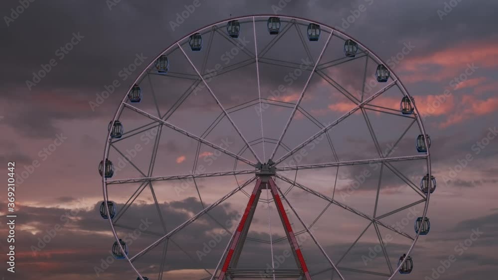 Large Ferris wheel with backlight in evening at sunset Large Ferris wheel with backlight in evening at sunset