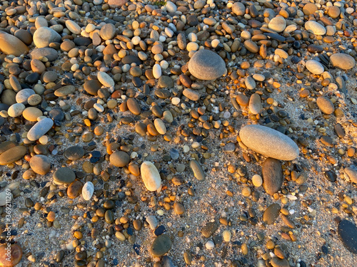 Cobble stone beach background texture close up at sunset in Esposende, Portugal. photo