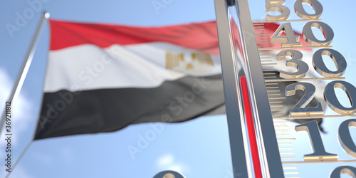 30 degrees centigrade on a thermometer measuring air temperature near flag of Egypt. Hot weather forecast related 3D rendering photo
