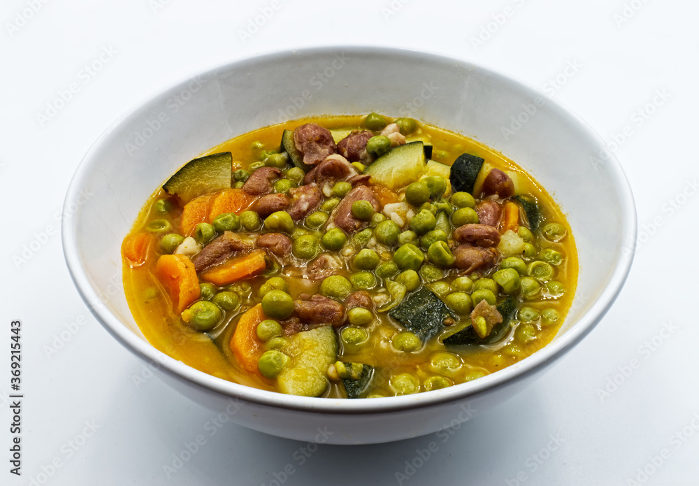 Vegetable soup in a bowl, isolated on white background   