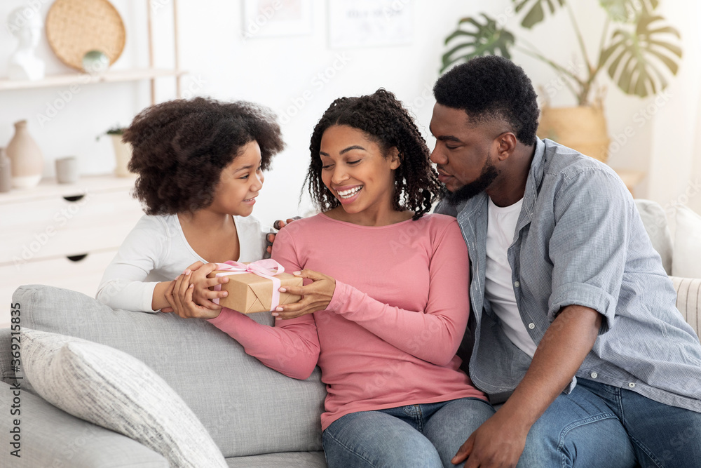 Mother's Day Surprise. Cute Little Girl Presenting Gift To Her Black Mom Mother's Day Surprise. Cute Little Girl Presenting Gift To Her Black Mom