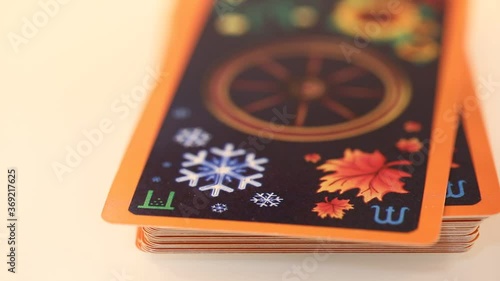 sorting out tarot cards wheel of the year laid out on a white table, close-up