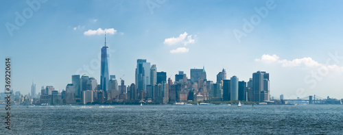 Panorama manhattan skyline from hudson river with blue sky and summer cloud from liberty island. New-York, United States.
