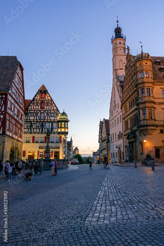 people enjoy a beautiful summer evening in in the market square of Rothenburg