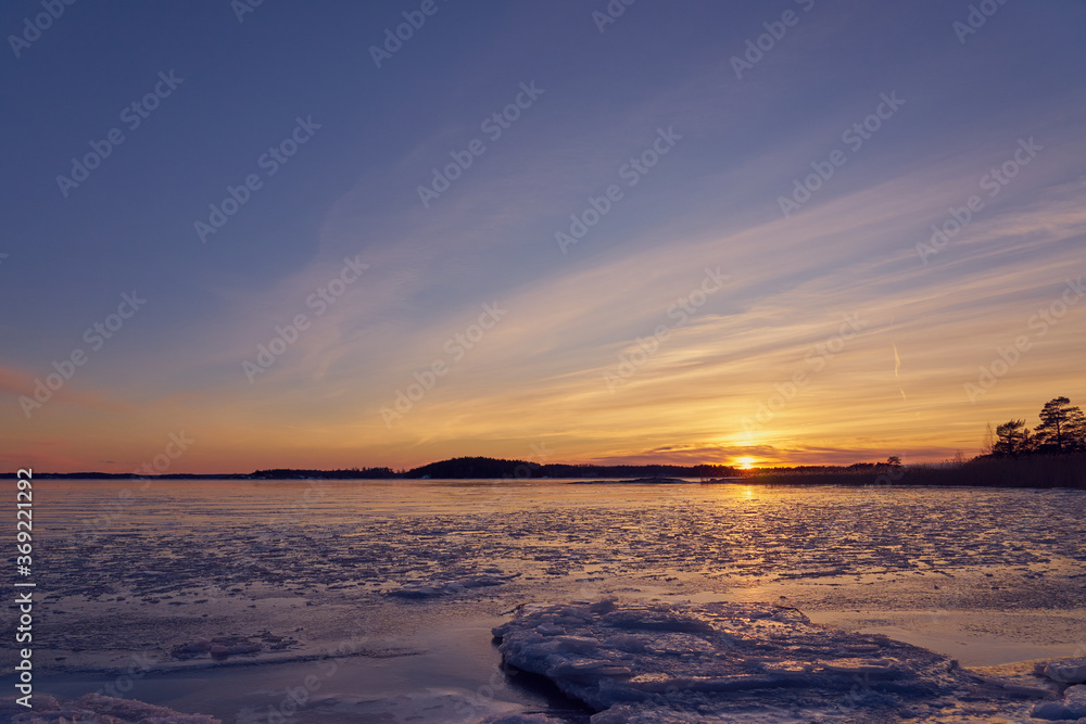 Frozen beach and icy sea on a sunset in Ruissalo, Finland.