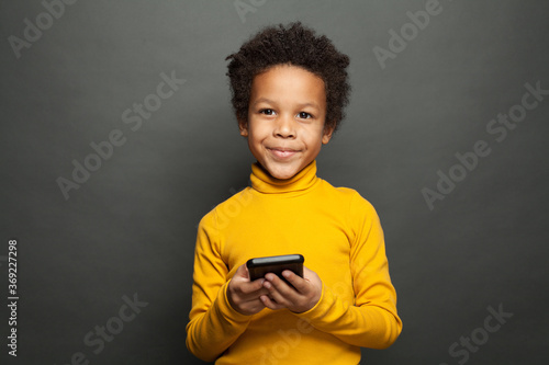 Happy African American child using smartphone