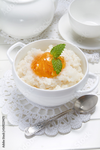 Rice porridge with orange marmalade and lemon balm leaves