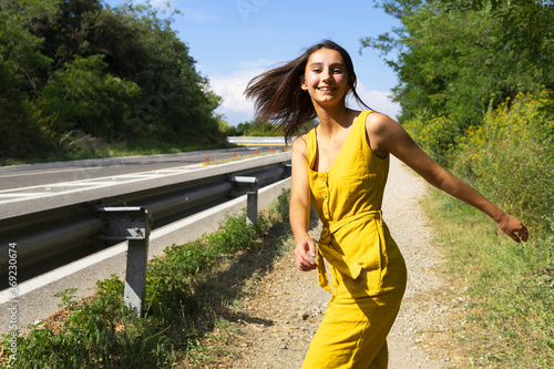 Woman dressed in yellow dancing on the street. Concept of taking a dance lap.